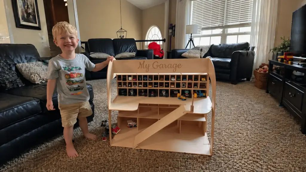preschooler playing with a toy car garage