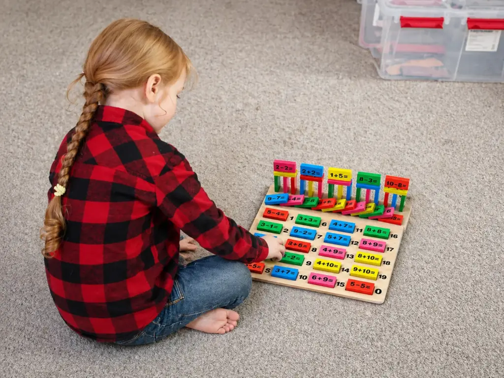 preschooler playing with domino set