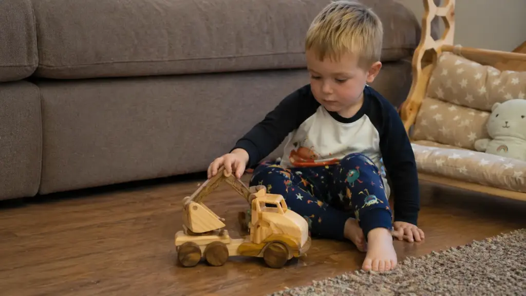 preschooler playing with excavator toy