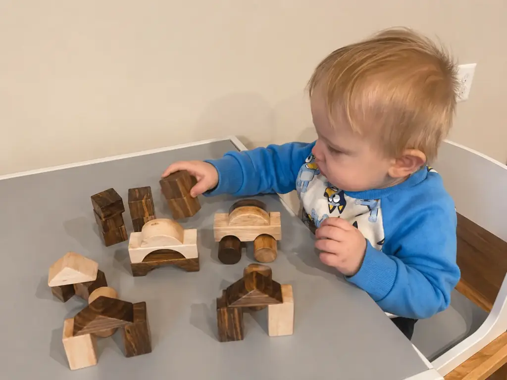 toddler playing with 29 piece building block set