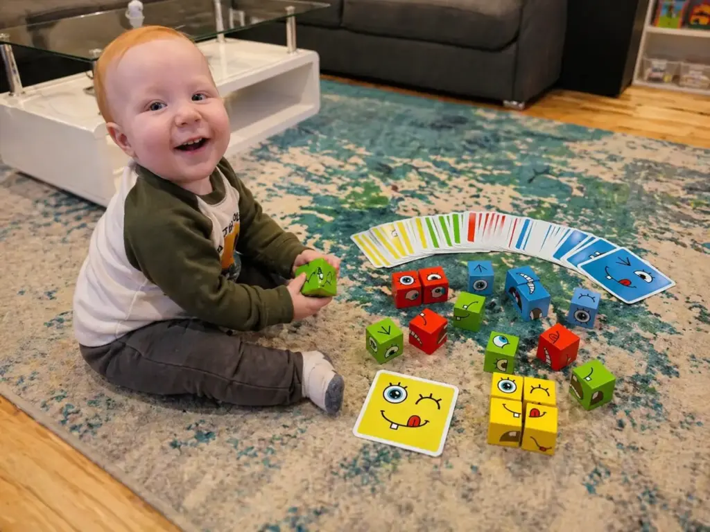 toddler playing with cube face building blocks