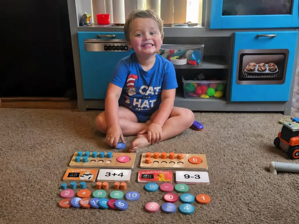 toddler playing with ten frame math set