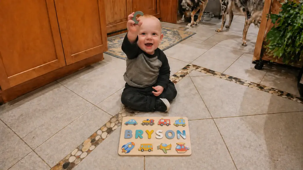 toodler playing with vehicle puzzle