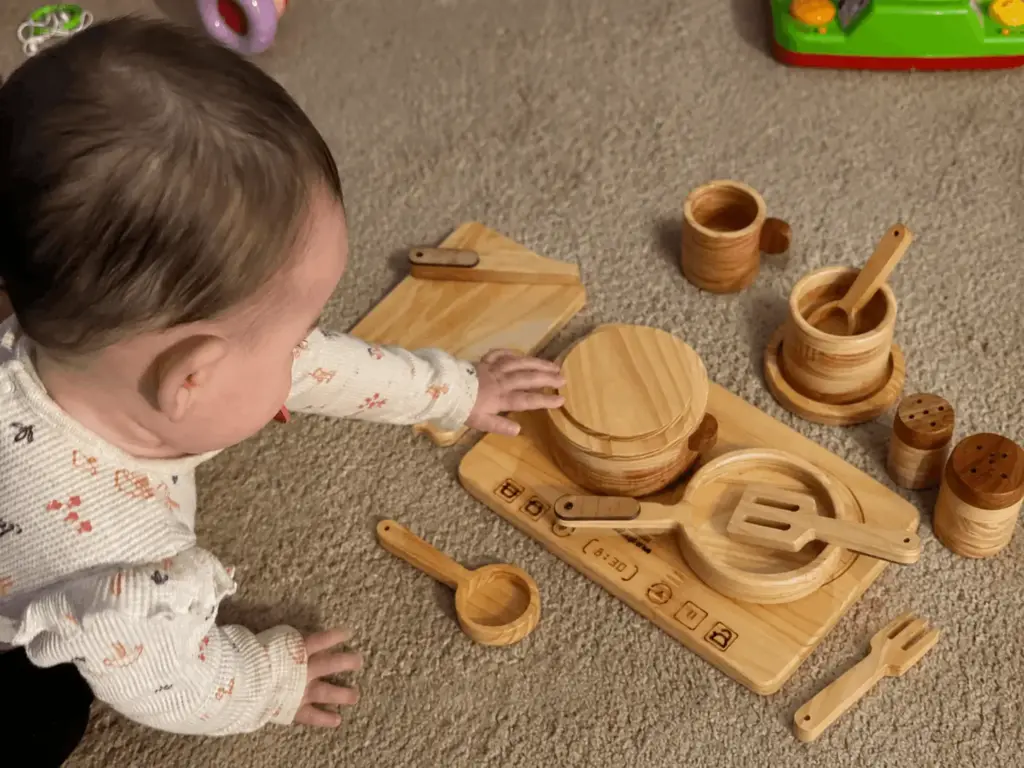 baby exploring cooking set