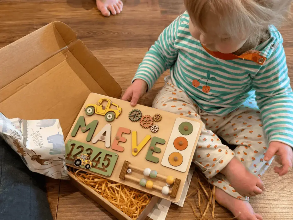 baby exploring vehicles and numbers