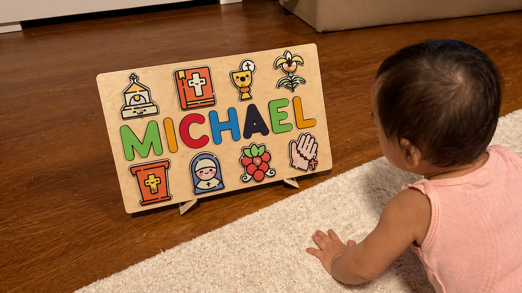 toodler playing with name puzzle