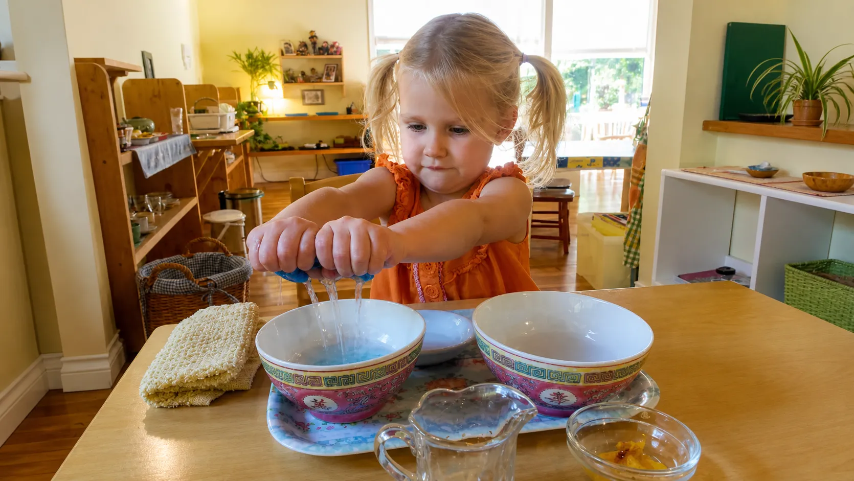 Little Girl Squeezing Sponge